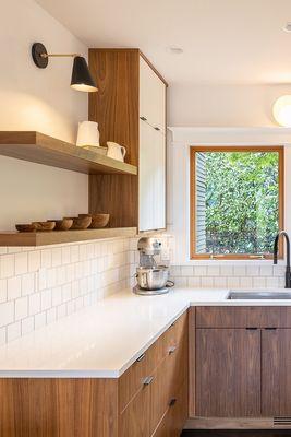 Custom black walnut, painted flat panel and open shelving.