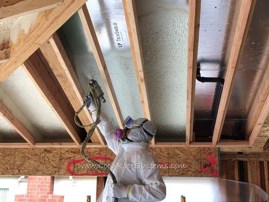 Spray foam insulation in progress.