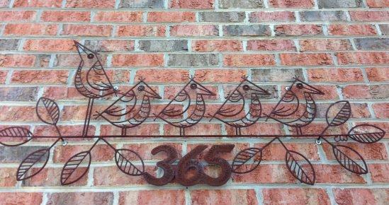 Birds and building number by artist Craig Wilson.