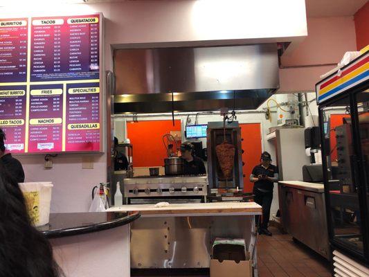 The kitchen and the adobada meat on the spinner!