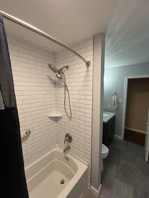 Beautiful new tub,  subway tile, shelf and grab bar