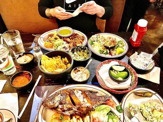 Mojarra frita (fried fish), ensalada marinera (avocado halves with shrimp), table-side guac, carnitas with avocado verde (green) salsa