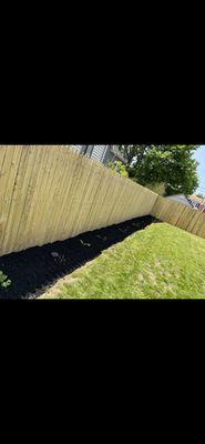 Hand edged border around fence, (Client) mulch job