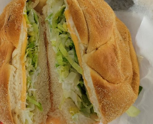 Two slices of cjeeoin a lettuce sandwich