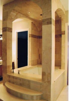 Custom jacuzzi with travertine pillars, ceiling, and steps home was viewed in the parade of homes.