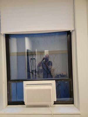 Windmill AC floating in the window with plexiglass surround.