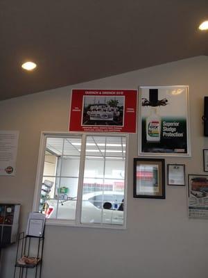 Inside the comfy waiting room with coffee, popcorn, newspaper.