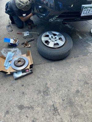 Employee changing brake pads and rotor!