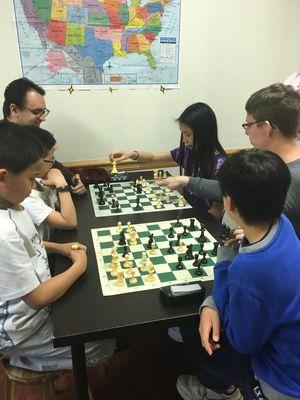 Coaches Mark and John playing Bughouse with students.