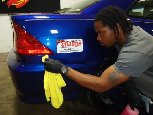 Trainee making sure the car is spotless!