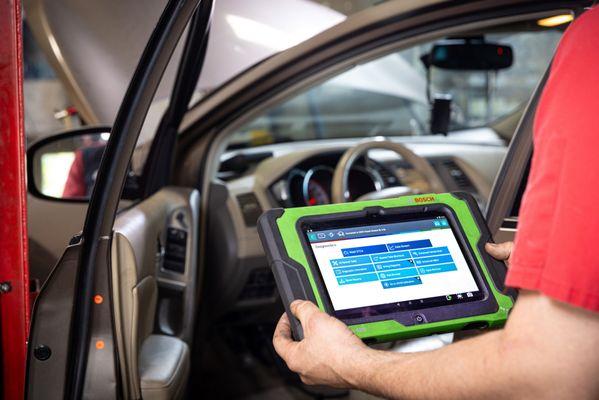 mechanic conducting car diagnostics test