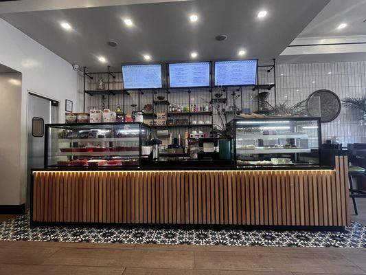 Counter where you order, and displays of side dishes and pastries/croissants