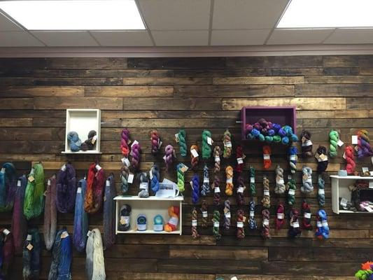 Display wall of hand dyed yarns.