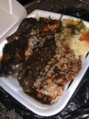 This photo is the sml jerk chicken plate extra gravy rice and peas and cabbage . Added diff Caribbean hot sauces they have . Store bought .