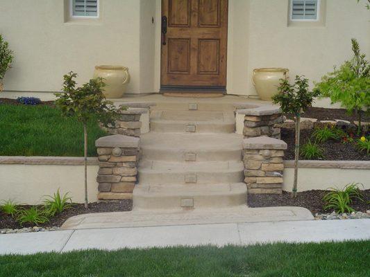 Entrance concrete, lighting, columns, retaining wall.