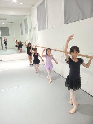 Beginning Ballet in 4th position at the barre