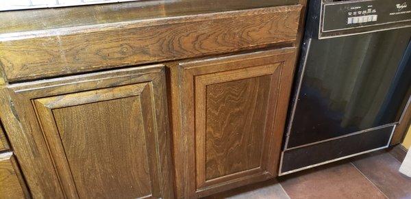 Finish applied over dirt, scratches and stains on cabinet doors