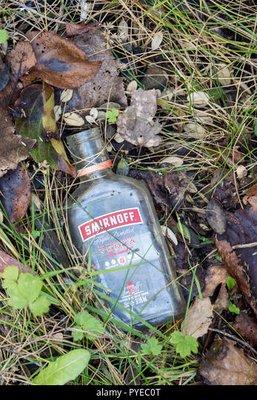 Tiny bottles of Smirnoff all over the backyard