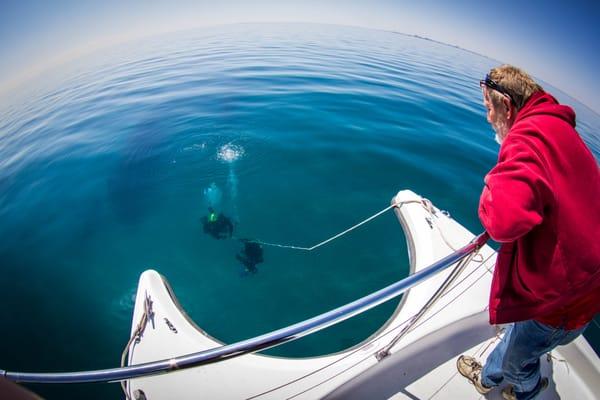 Captain Keith Checking up on the divers in the crystal clear water of Lake Michigan