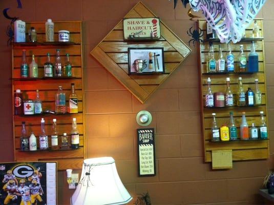 A cool collection of old hair and shaving products is displayed on the wall.