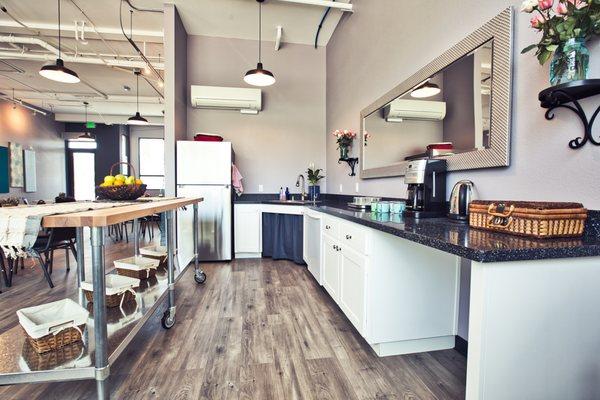 Demo Kitchen with full size refrigerator, dishwasher, sink, and purified water system.