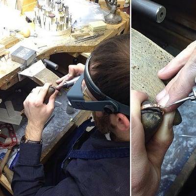 Blaine Allmond, designer and bench jeweler, hand-setting diamonds in a wedding band.