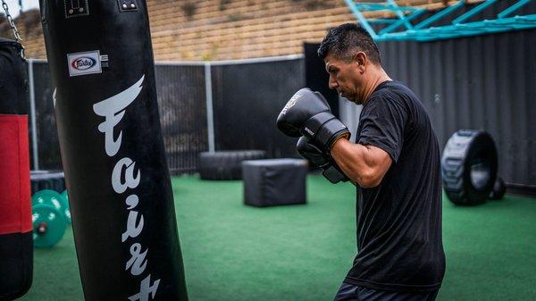 Working Out with Punching Bags - Turf Training Area Outdoors at San Diego Personal Training