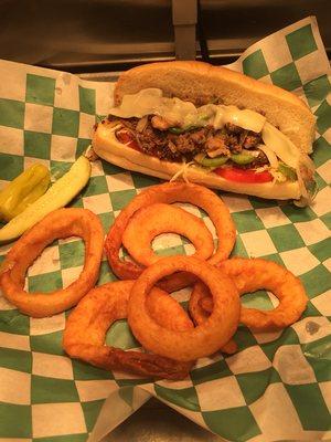 Philly cheese steak green peppers, cheese, onions, mushrooms, letters and tomatoes. And onion rigs on the side so delicious.