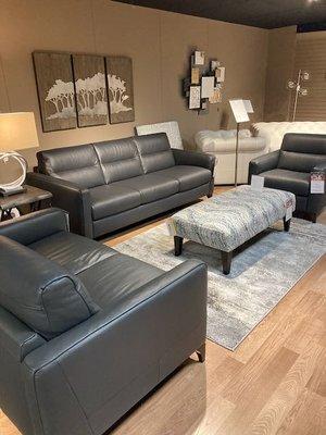 Leather group with accent ottoman and rug.