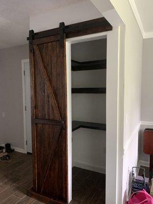 Custom made pantry-- walls, shelves, barn door