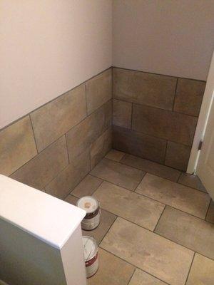 Wall and floor tile come together for nice finished look behind door