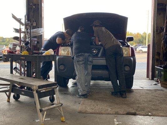 The guys, going over my new (to me) car, with a fine-toothed comb.