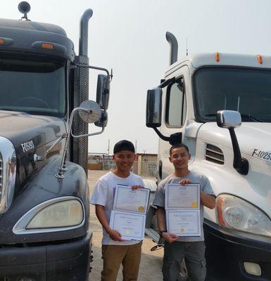 Graduates of Sage Truck Driving School holding their certifications.