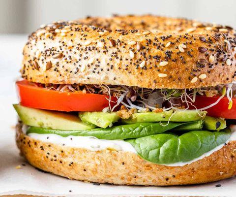 Veggie bagel sandwich with avocado, tomatoes, cream cheese