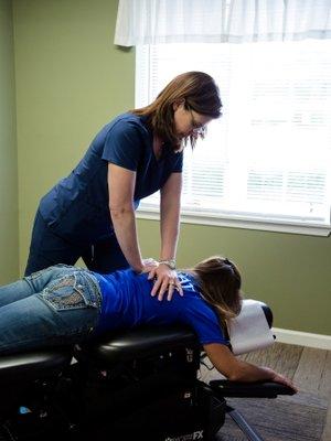 Dr. Ducat performing a chiropractic adjustment.