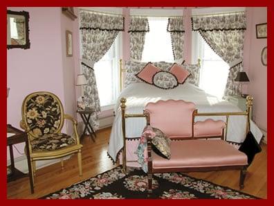 The Sewing Room - queen-sized bed with fireplace and stained glass in the bathroom.