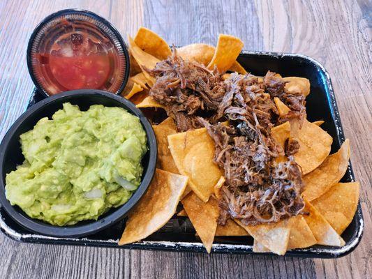 Nachos top with beef & side of fresh delicious guacamole