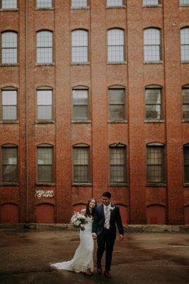 Couple outside their winter wedding venue at Rivermill at Dover Landing in Dover New Hampshire