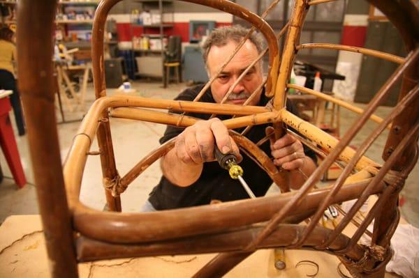 Master Craftsman Mark DeVito repairing an antique chair.