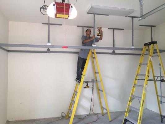 Nathan installing our custom built 4x16' overhead rack.