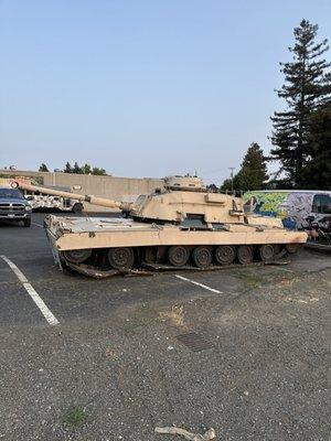 Beige US military tank outside of the venue, next to the parking lot