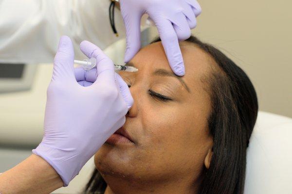 Image of an injectable treatment in progress with a patient