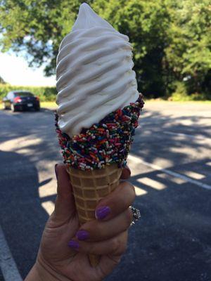 Vanilla soft serve in chocolate sprinkle cone