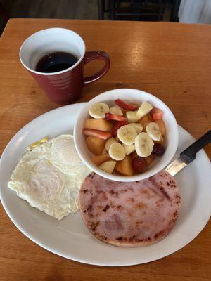 2 eggs over easy with a ham steak. A large bowl of fruit, and coffee!