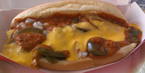 Swimming underneath the chili like topping, cheese, jalapeno, and diced onions is a bacon wrapped hotdog.  Unhealthy goodness.