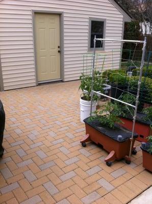 Holland stone pavers set in a herringbone pattern.  Tan and buff color set a crushed concrete and sand pad.