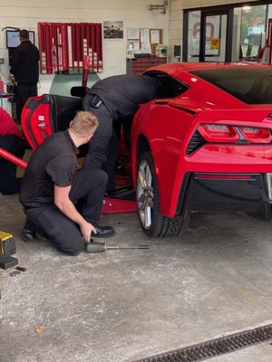 Pit crew working together to get my car back onto the track.