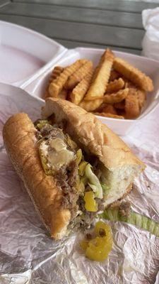 Steak Philly with lettuce, tomato, onion, and banana peppers.