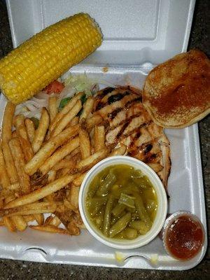 Chicken Sandwich with a spicy bbq sauce, green beans, fries and corn on the cobb.