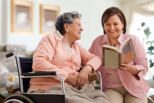 Caregiver reads to a client.